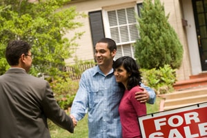 An image of a couple being congratulated on buying their home