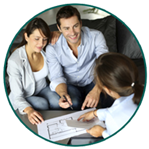 A young couple sitting across from another woman, the three of them looking over an apartment blueprint. The man holds a pen and the woman on the other side of the table points at the paper. They could be discussing the couple's custom Windsor property management plan.